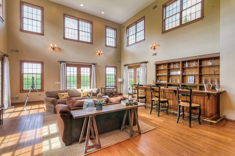 A two-story great room allows for plenty of light. Learn more at NewJerseyLuxuryAuction.com.