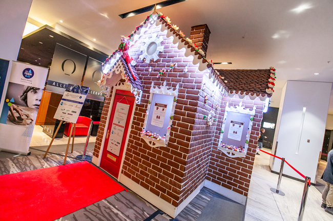 Now through January 6, 2019, this fourteen-foot-tall gingerbread house designed by Pastry Master Jean-Luc Piquemal will welcome hundreds of travelers. Credit: Hilton Hotels & Resorts